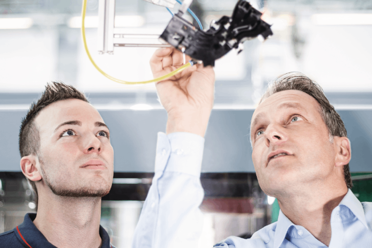 A production engineer and component designer look at details of an injection moulded plastic automotive component