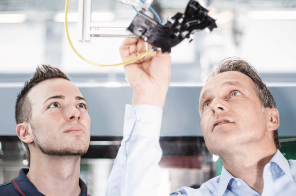 A production engineer and component designer look at details of an injection moulded plastic automotive component