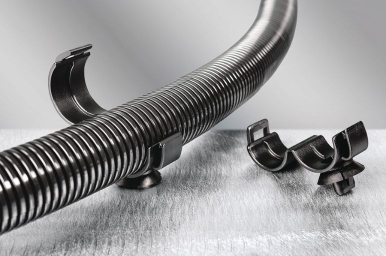 Convoluted corrugated tube clamp for fluid routing in vehicles