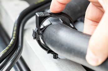 Locking clip with hole mounting interface for fluid line assembly in vehicles