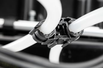 Ratchet O-Clamp holding parallel fluid lines securely