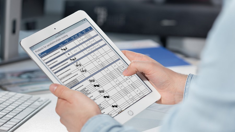 Scrolling through HellermannTyton Automotive Fluid Routing Solutions brochure on a tablet