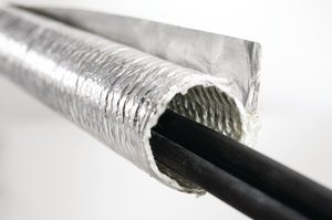 Aluminum laminated fiberglass wrap sleeving combines the protection of bonded aluminum and fiberglass into a robust solution that deflects radiant heat away from sensitive wires and cables.