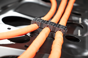 A high-voltage clip with a soft component designed for safe cable management and optimized NHV (noise, harshness, and vibration) performance in automotive applications