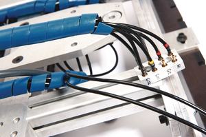 Detectable, metal-content spiral binding protects cables on food-processing machines.