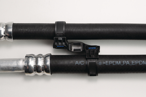 The Soft Grip Tie in combination with the Soft Grip Mount for studs (weld studs) for parallel guidance of hoses in fluid management.