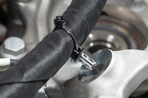 Custom‑length cable tie with manually applied closure head, combined with an 8.0 mm blind hole mount for secure routing on cast components; suitable for hand installation or automated processing with ATS systems from HellermannTyton.