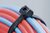 Outside serrated OS-Series cable tie with smooth surface to the bundle.